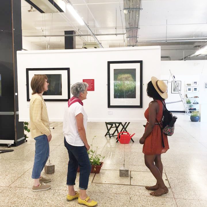 Three women viewing artwork in the gallery