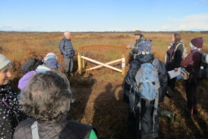 people viewing a sculpture on the art trail at Wixall Moss